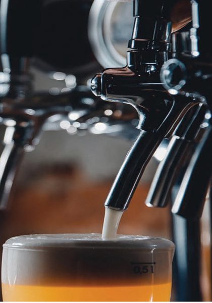 Draught beer being poured from a tap by The Draughtman